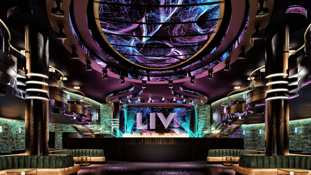 The lobby of a nightclub illuminated with purple lighting and custom LED displays, enhancing the lively ambiance.
